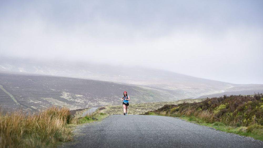 A lone runner on the misty Military Road